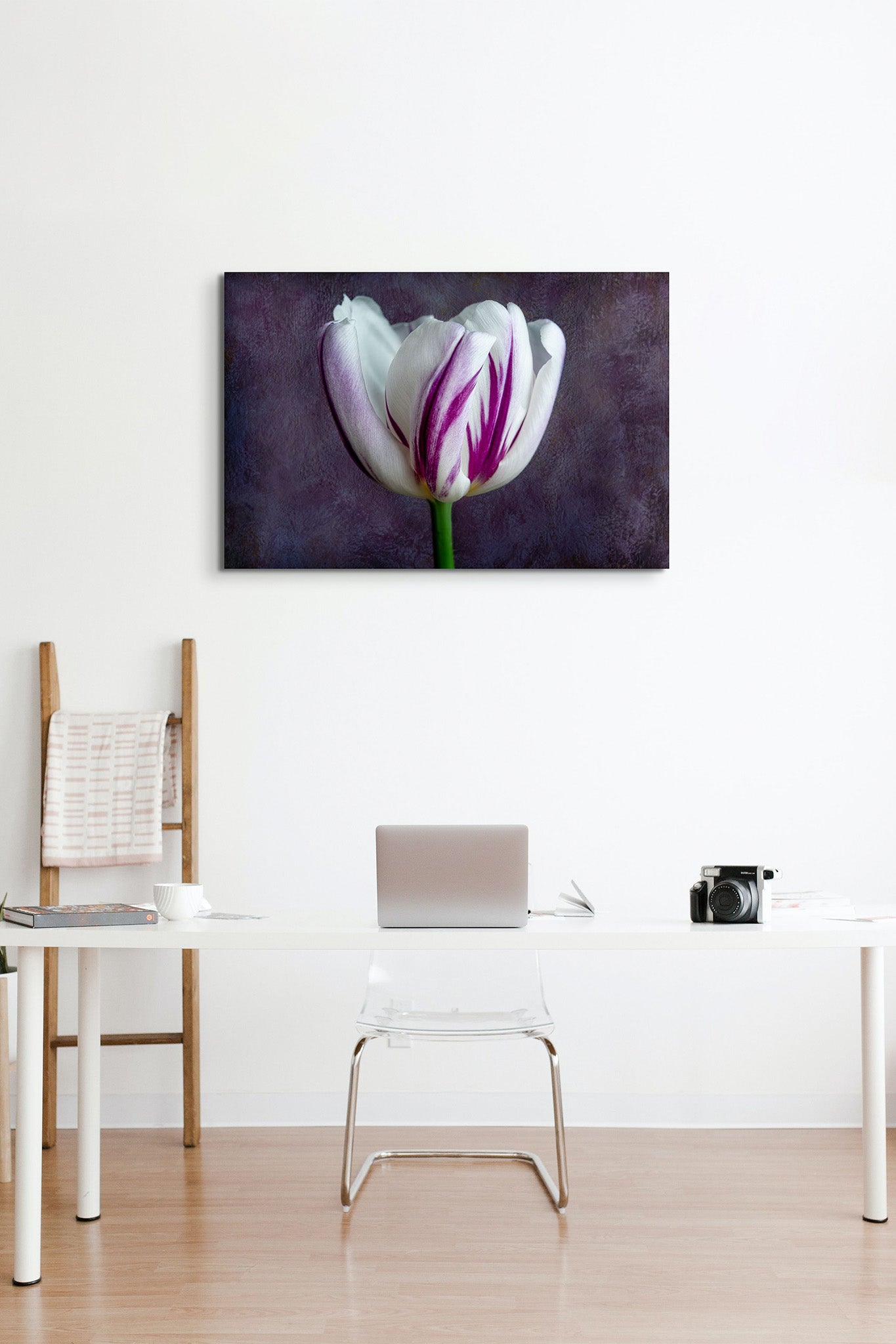 Picture hanging on the wall of an office. There is a desk with a laptop on it. The picture is a fine art flower photograph of a single tulip titled "Audrey" by Cameron Dreaux of Dreaux Fine Art. 