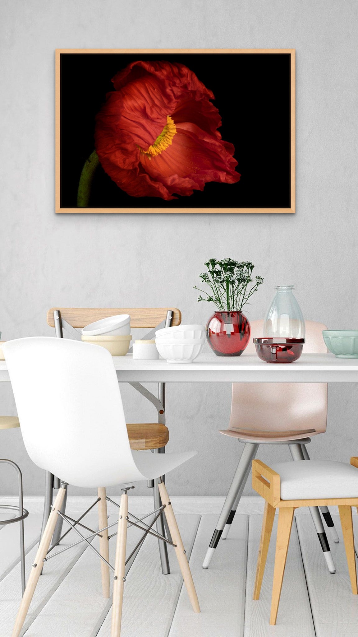 Picture hanging on the wall of a dining room with a set table. The picture is fine art Flower Photography of an Icelandic Poppy titled "Bashful" by Cameron Dreaux of Dreaux Fine Art. 