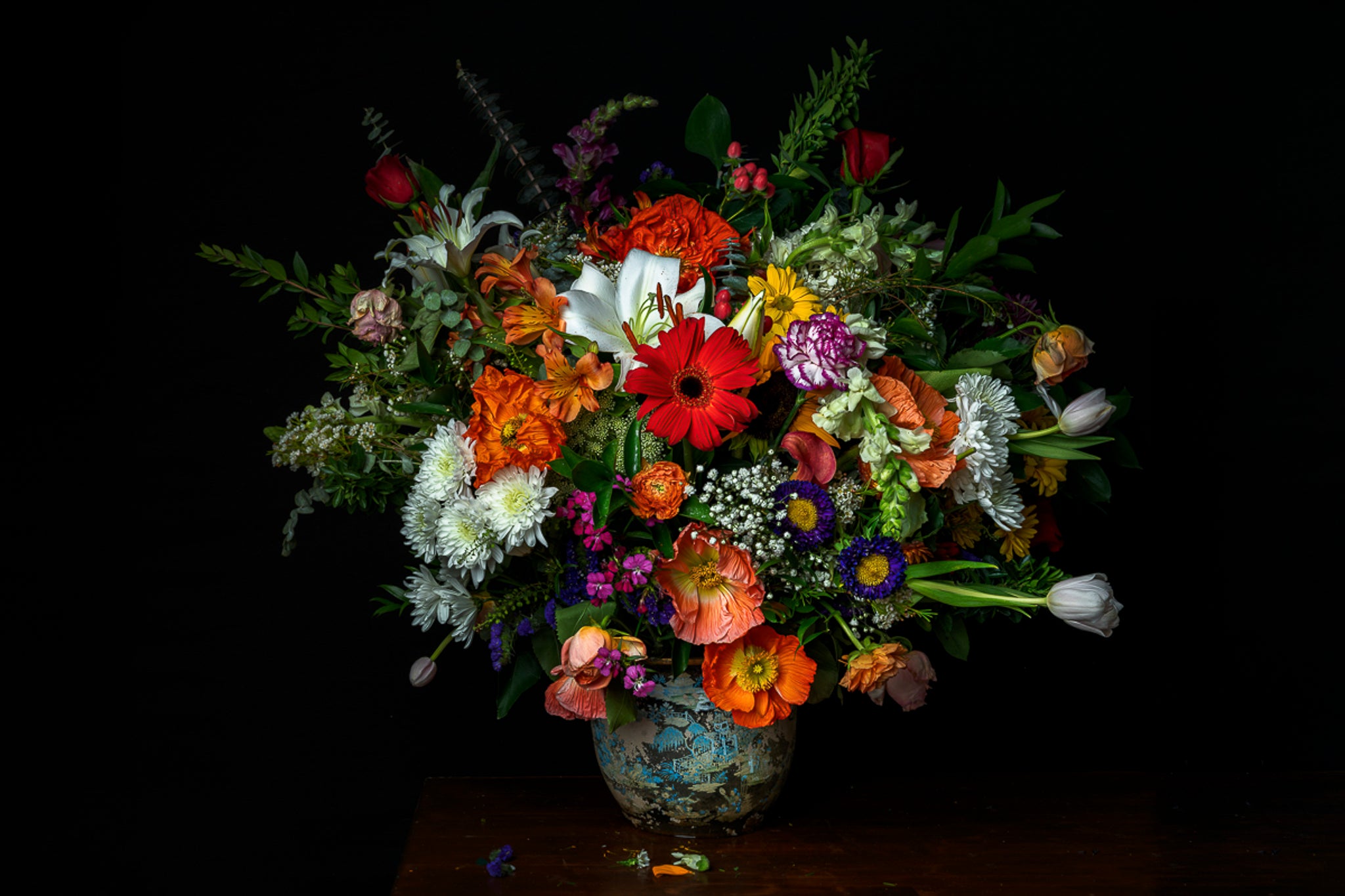 A metal print from Dreaux Fine Art of "A Generous Gift." "Generous Gift" is a photograph of a bouquet of various types of flowers on a black background.