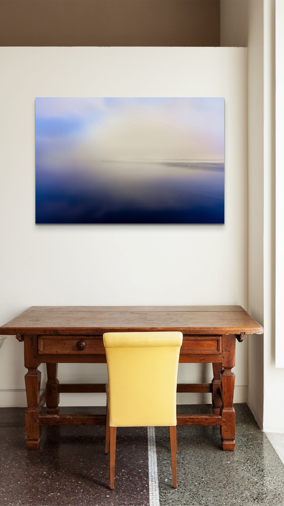 Picture hanging on the wall of an office over a desk. The picture is a fine art landscape photograph titled "Go Toward the Light" by Cameron Dreaux of Dreaux Fine Art.