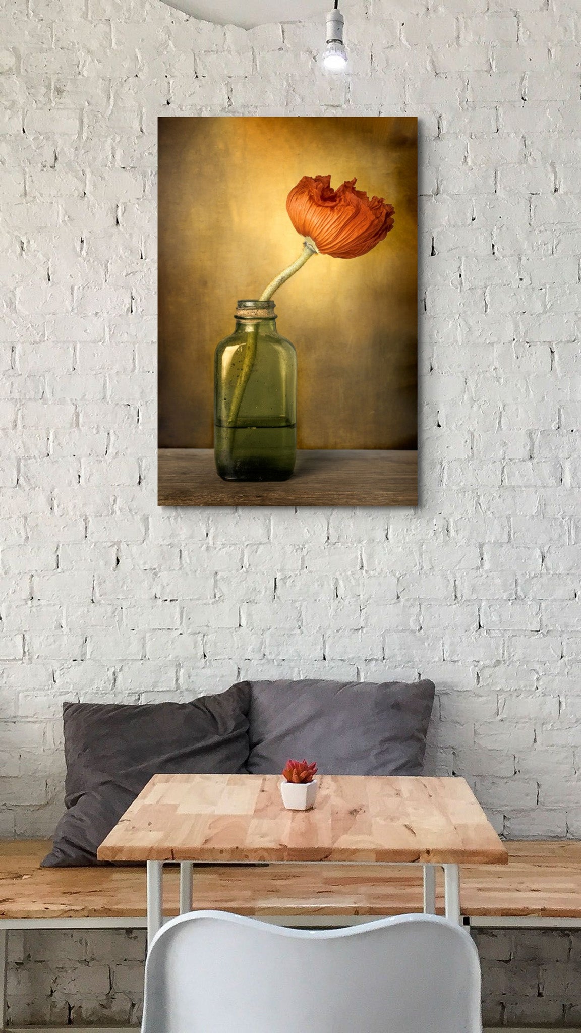 Picture hanging on the wall of a coffee shop. The picture is a fine art flower photograph of a red poppy in a vintage bottle titled "Hope is a Journey" by Cameron Dreaux of Dreaux Fine Art.