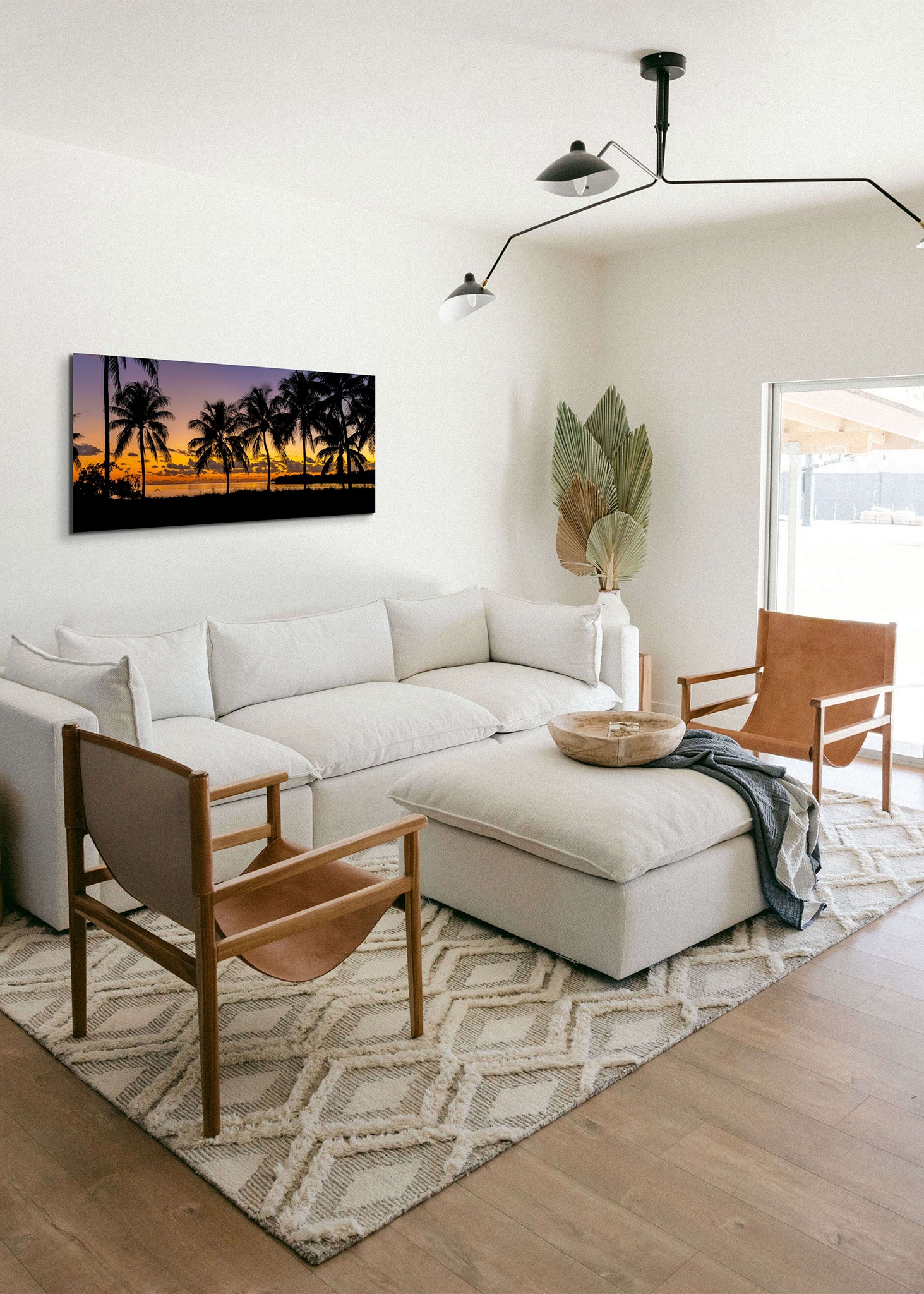 Picture hanging on the wall of a living room over a white sofa. The picture is a fine art landscape photograph titled "Nautical Twilight" by Cameron Dreaux of Dreaux Fine Art.
