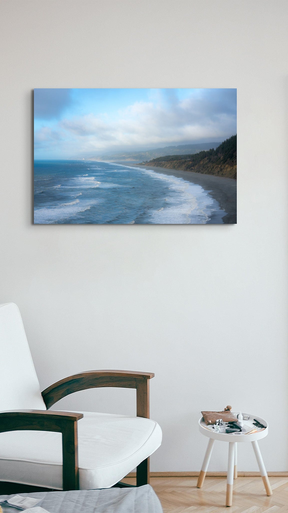Picture hanging on the wall of a room over a chair. The picture is a fine art landscape photograph titled "Coastal Tide" by Cameron Dreaux of Dreaux Fine Art.