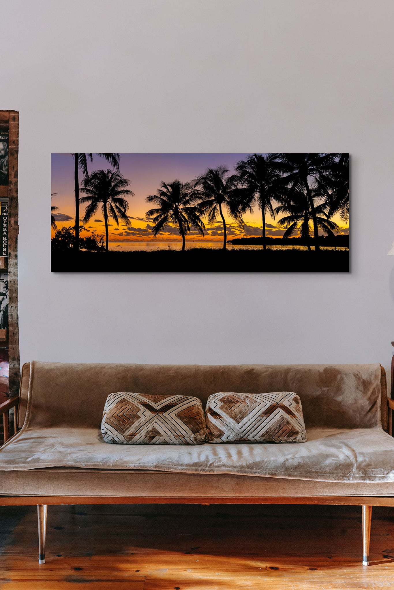 Picture hanging on the wall of a living room over a beige sofa. The picture is a fine art landscape photograph titled "Nautical Twilight" by Cameron Dreaux of Dreaux Fine Art.