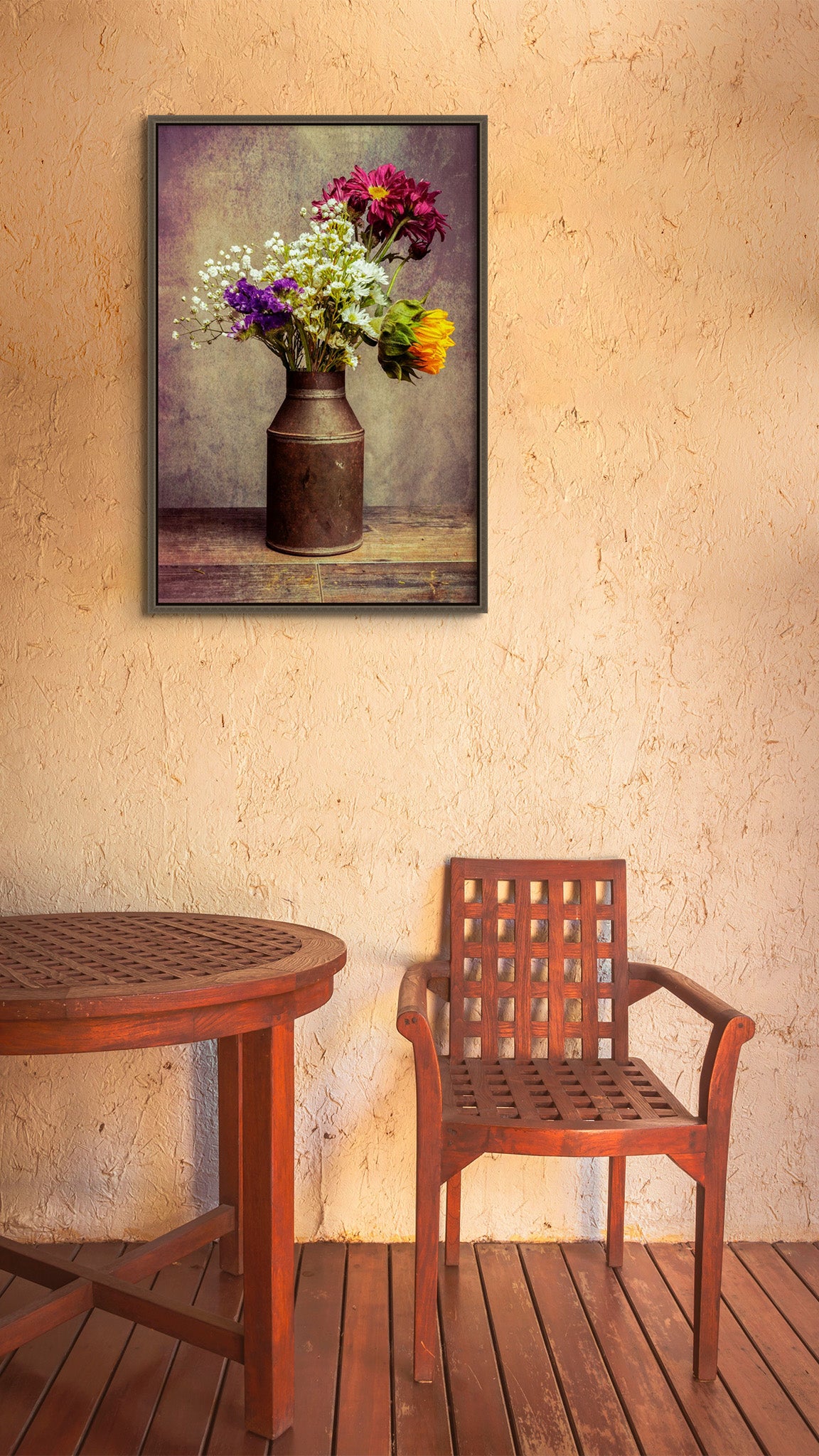 Picture hanging on the wall of a dining room. The picture is a fine art flower photograph of a bouquet of flowers in a tin can titled "Ol' Tin Can" by Cameron Dreaux of Dreaux Fine Art. 