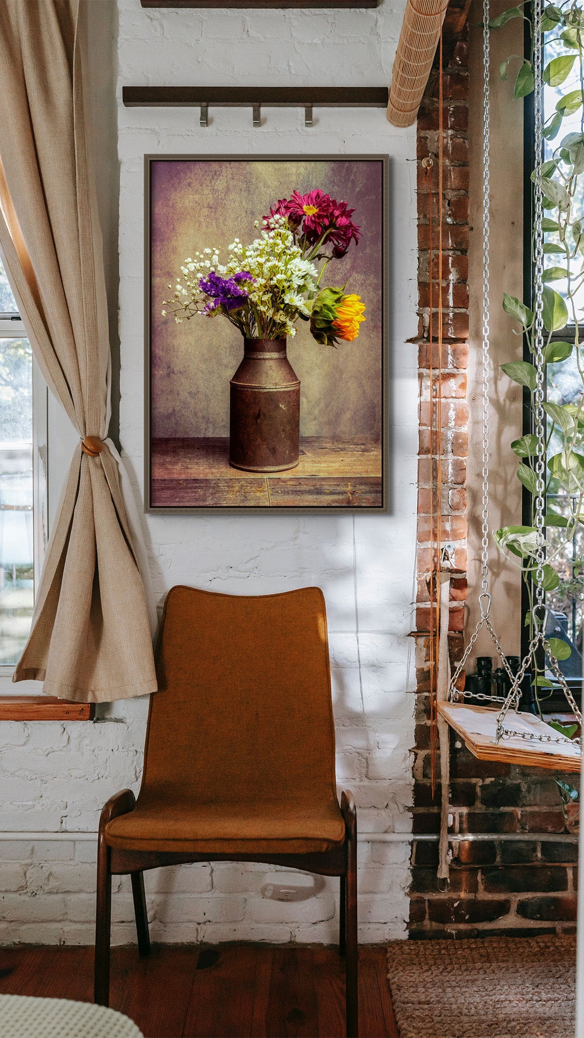 Picture hanging on the wall of a room with a chair below the picture. The picture is a fine art flower photograph of a bouquet of flowers in a tin can titled "Ol' Tin Can" by Cameron Dreaux of Dreaux Fine Art. 