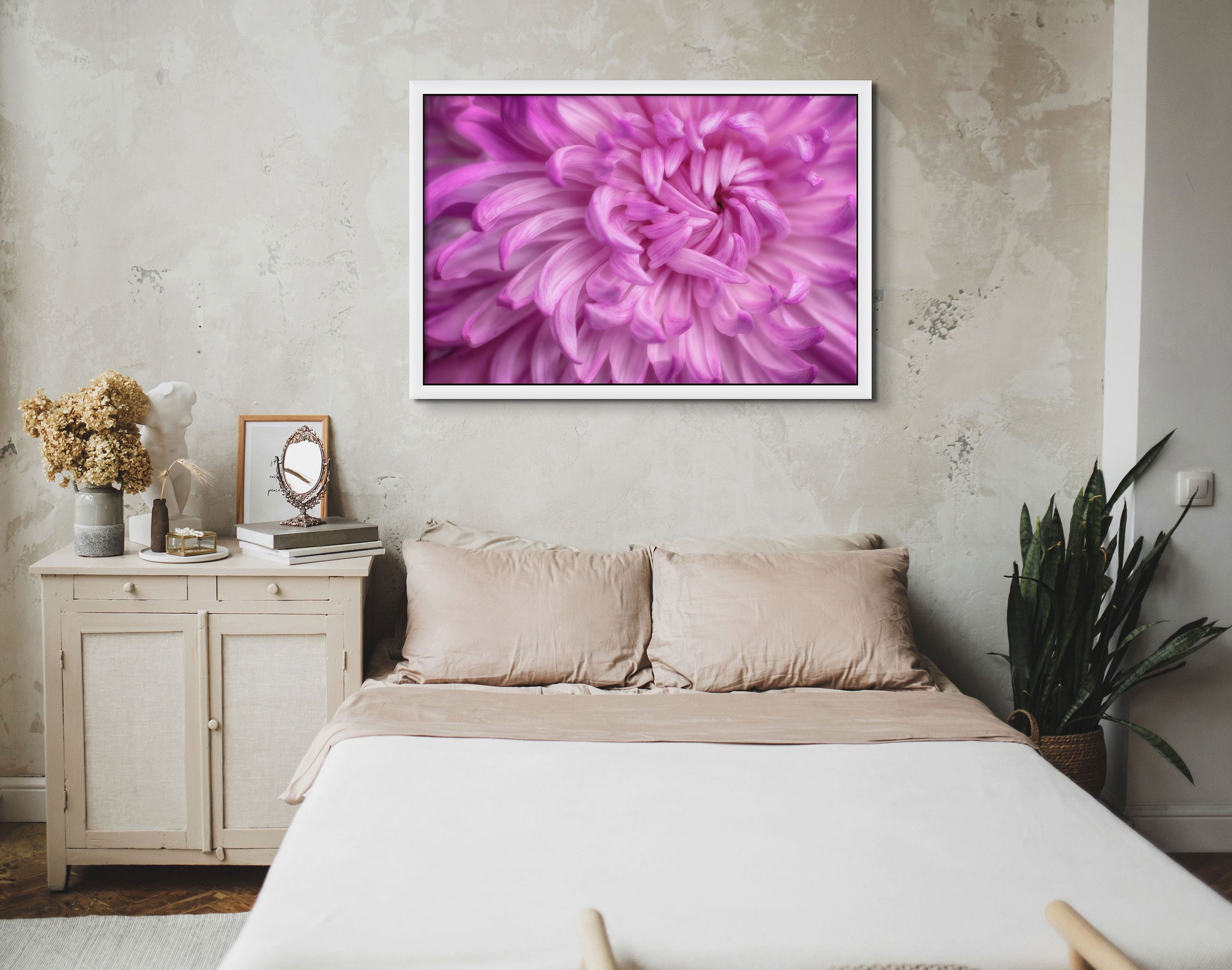 Picture hanging on the wall of a bedroom. The picture is a fine art photograph of a pink Chrysanthemum flower titled "Self Love" by Cameron Dreaux of Dreaux Fine Art. 
