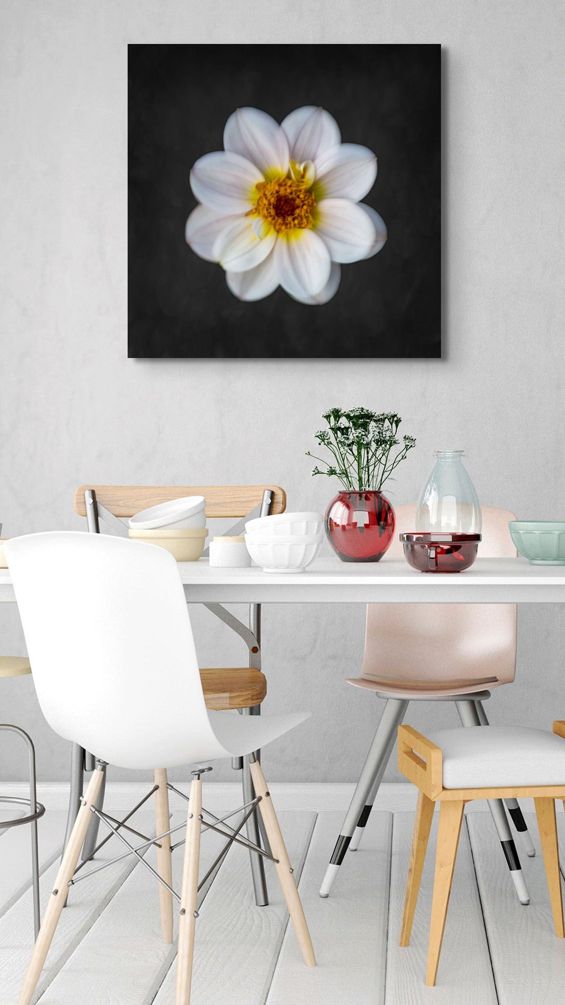 Picture on the wall of a dining room with a set table and chairs. The picture is a fine art photograph of a white dwarf dahlia against a black background. Photo by Cameron Dreaux of Dreaux Fine Art. 