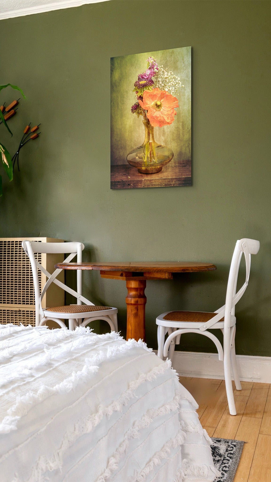 Picture hanging on the wall of a bedroom. The picture is a fine art flower photograph of a bouquet with an orange Icelandic poppy titled "Speakeasy" by Cameron Dreaux of Dreaux Fine Art.
