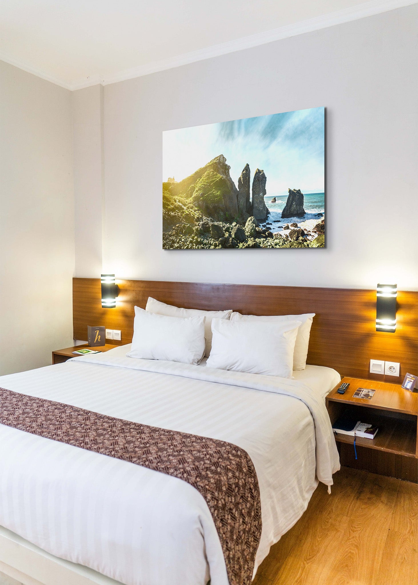 Picture hanging on the wall of a hotel room over a bed. The picture is a fine art landscape photograph titled "Sue-Meg" by Cameron Dreaux of Dreaux Fine Art.