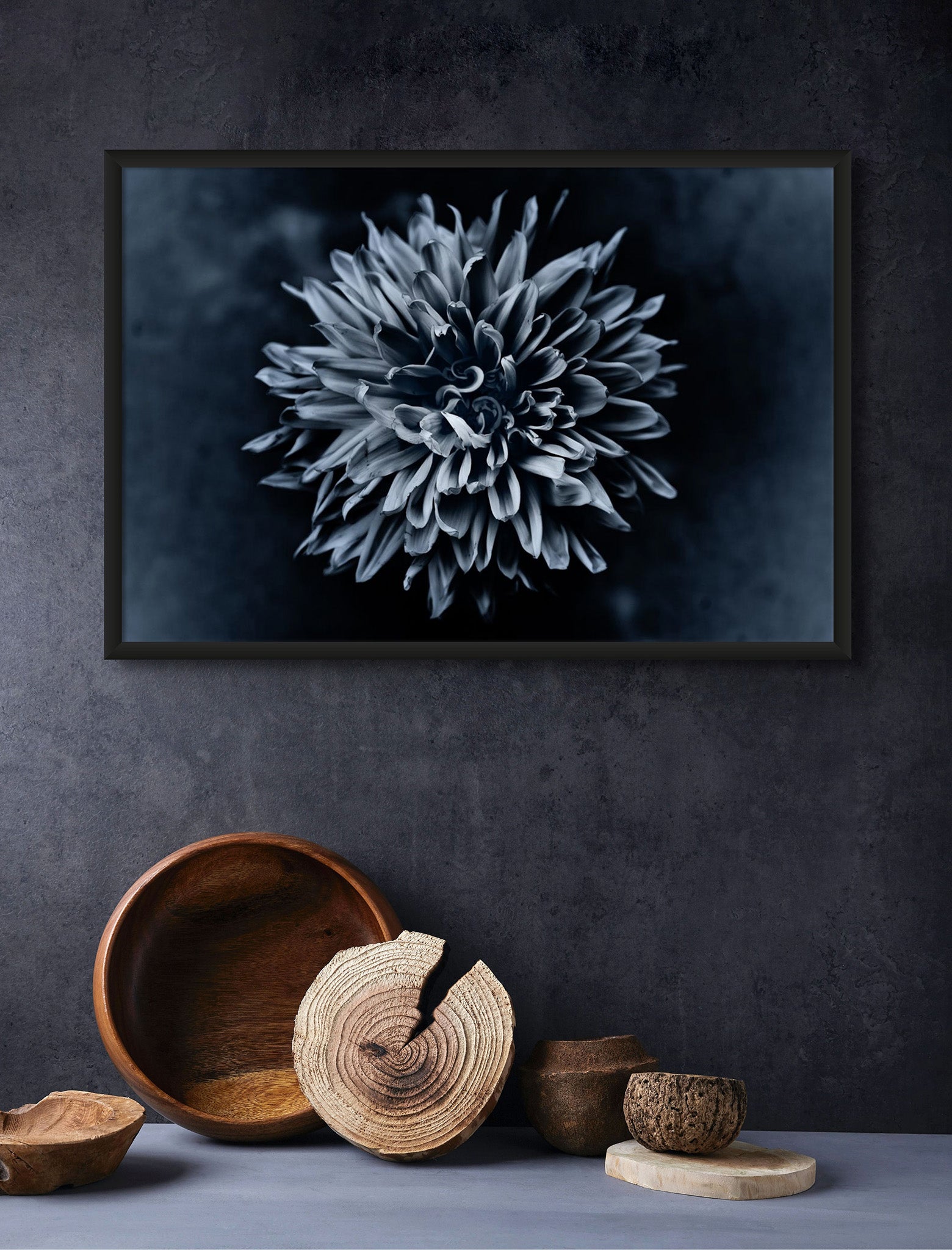 Flower photography hanging on the wall with some straw pots below it.  The Photograph is Black Dahlia by Cameron Dreaux Titled "Black Dahlia No. 1." The photograph is a black and white flower photo of a Dahlia flower. 