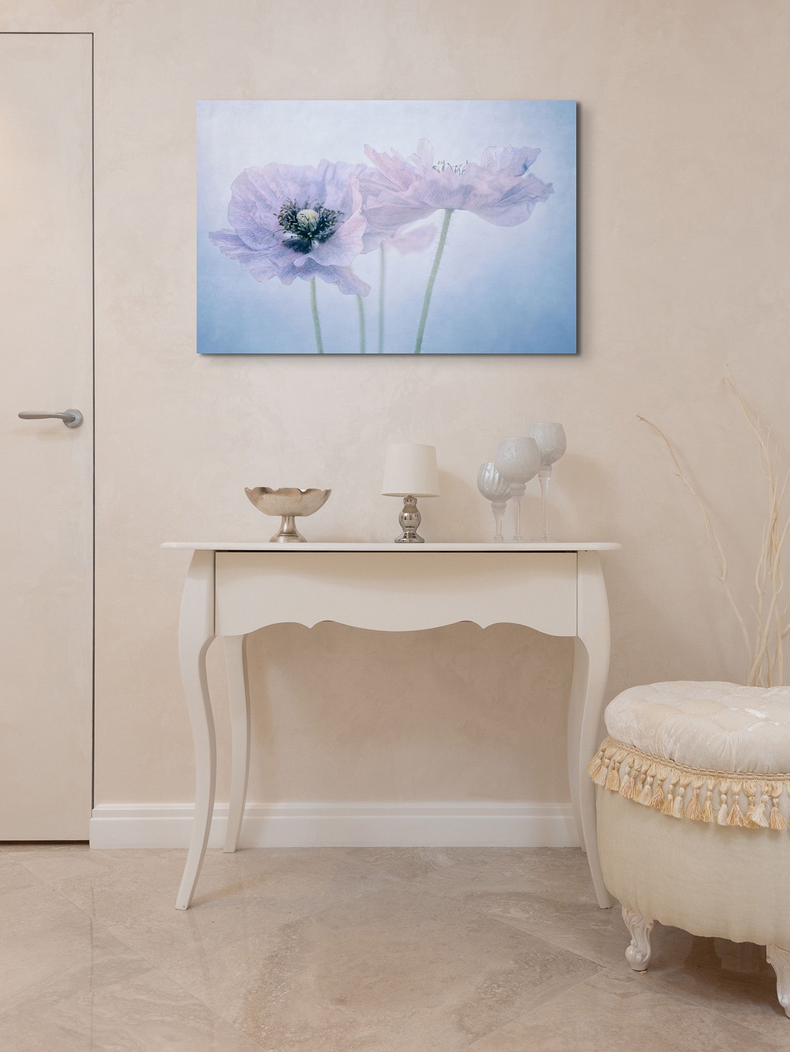 A picture on wall over a vanity.  The picture is a fine art flower photograph by Cameron Dreaux. of 3 pastel-colored poppies. 